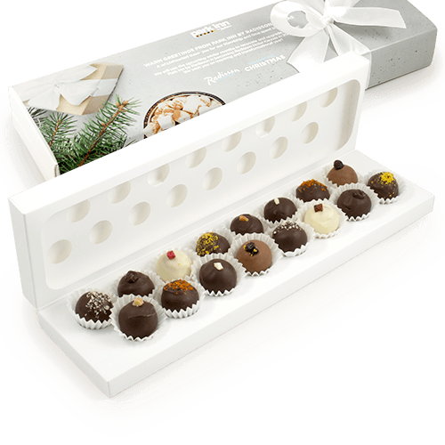 Handmade truffles in white box with logo. The refined combination of chocolate 
and natural fillings will surprise you. This is a great choice when quality and content of business gifts is important. The logo on the sleeve, on the postcard or on the satin ribbon in selected color.